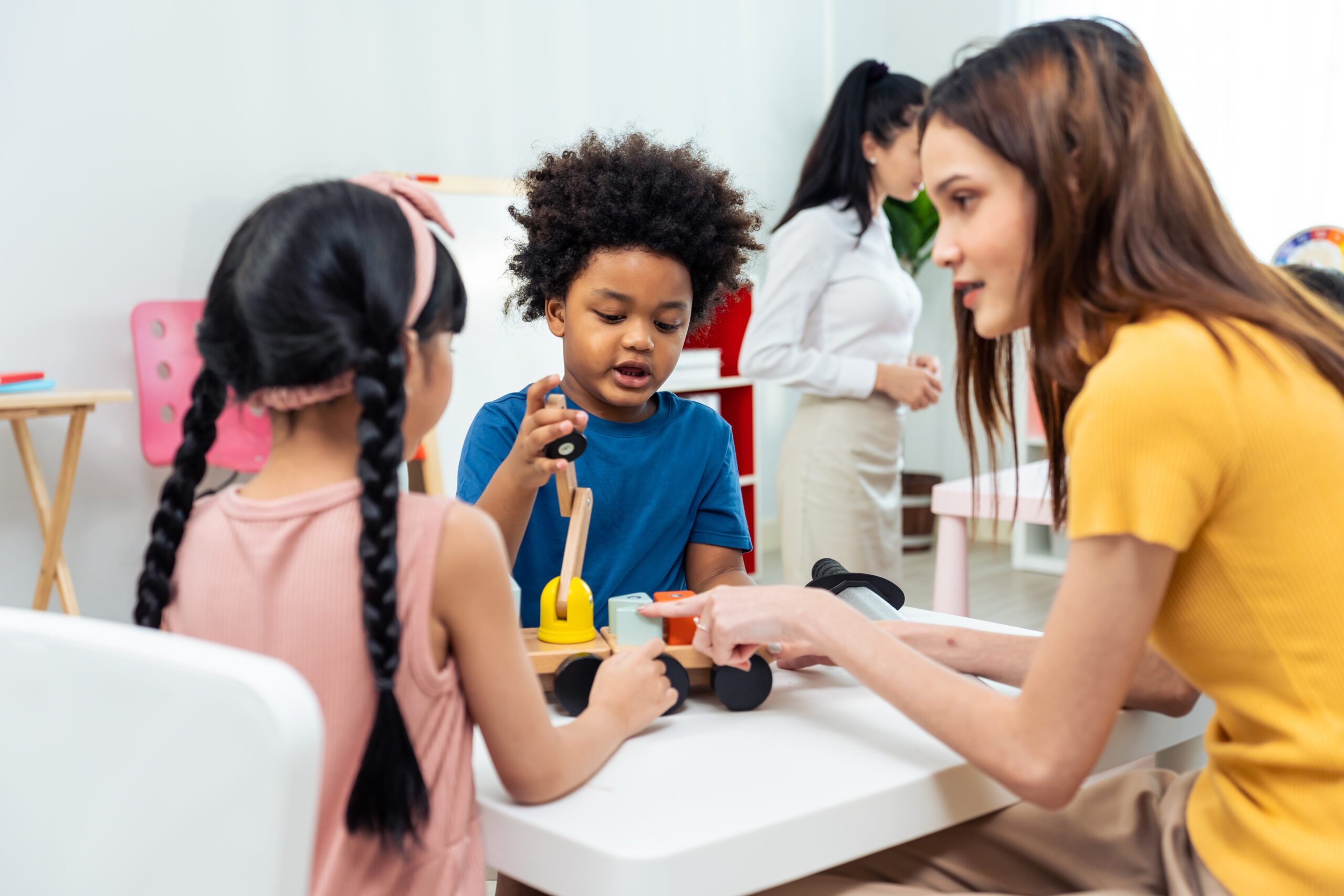Asian beautiful young woman teacher teaching art to kids at school. Attractive Instructor master female explain and educate draw and painting, palying with student kindergarten pre school in classroom